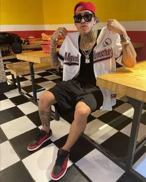 Tattooed Man Sporting Baseball Jerseyand Cap Wallpaper