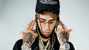 Tattooed Manwith Jewelryand Cap Wallpaper