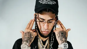 Tattooed Manwith Jewelryand Cap Wallpaper