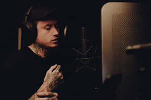 Tattooed Musician Recording Session Wallpaper