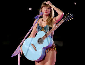 Taylor Swift Blue Guitar Performance Wallpaper