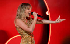 Taylor Swift Delivers A Stunning Performance In Her Red Taylor's Version Album Wallpaper