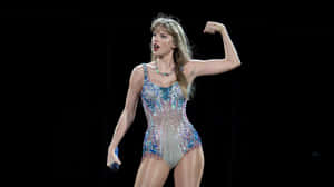 Taylor Swift Performingin Sparkling Outfit Wallpaper