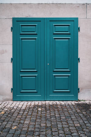 Teal Door On Gray Wall Wallpaper