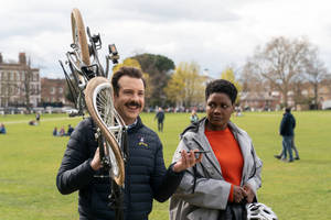 Ted Lasso Holding A Bike Wallpaper