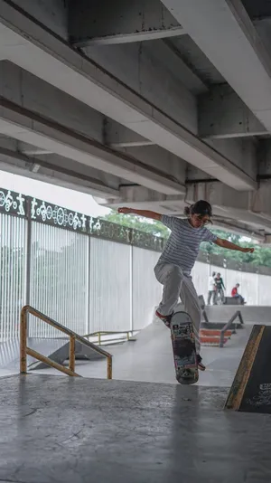 Teenage Girl Having A Skateboard Ride. Wallpaper