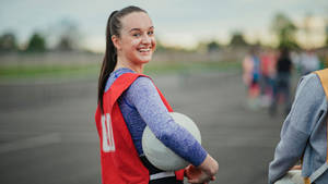 Teenage Girl Smile Playing Netball Wallpaper