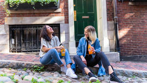 Teenage Girls Drinking Orange Soda Wallpaper