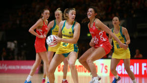 Teenage Girls Playing Netball Indoor Court Wallpaper