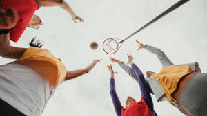 Teenage Girls Playing Netball Waiting Catch Ball Wallpaper