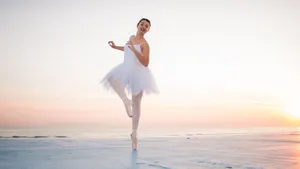 Tender Ballet Dancer Beach Pose Wallpaper