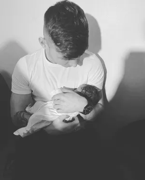 Tender Moment Fatherand Newborn Baby Wallpaper