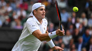 Tennis Athlete John Isner In Action Wallpaper