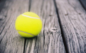 Tennis Ball On Wood Planks Wallpaper