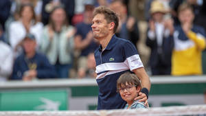 Tennis Legend, Nicolas Mahut, Celebrates Victory With His Son On Court Wallpaper