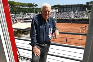 Tennis Legend Overlooking Clay Court Wallpaper