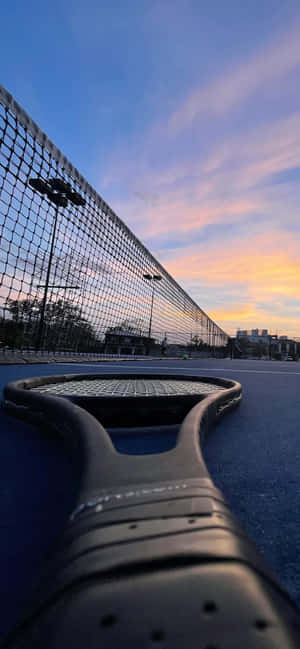 Tennis Racquetand Netat Dusk Wallpaper