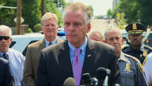 Terry Mcauliffe Articulating His Views Through Microphones. Wallpaper