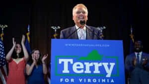 Terry Mcauliffe Delivering Speech At A Rally. Wallpaper