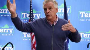 Terry Mcauliffe Speaking At A Political Rally Wallpaper