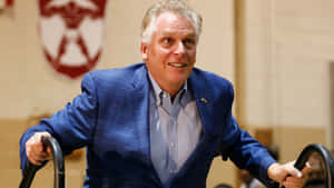 Terry Mcauliffe Walking Up To A Stage Wallpaper