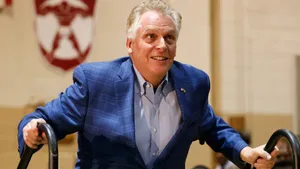 Terry Mcauliffe Walking Up To A Stage Wallpaper
