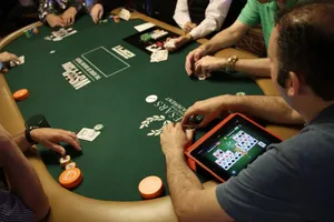 Texas Hold'em Player Engrossed In Online Game Wallpaper