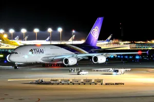 Thai Airways Airplane With Cargo Cars Wallpaper