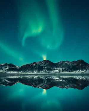 The Aurora Borealis Is Reflected In The Water Wallpaper
