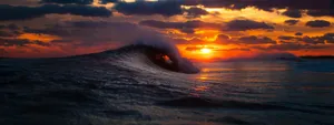 The Beauty Of A Unique Sunset Reflected In The Waves Wallpaper