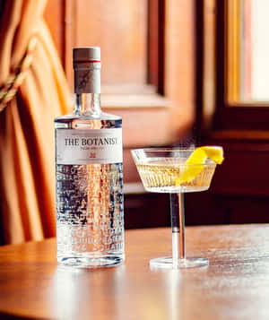 The Botanist Gin Alcoholic Drink On Table By The Window Wallpaper