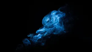 “the Captivating Beauty Of Smoke Dancing In The Night Sky” Wallpaper