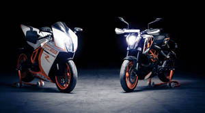 The Dynamic Duo - Ktm Duke 390 & Ktm 1190 Rc8 In Raw Action Wallpaper