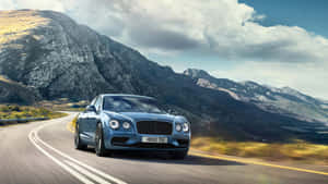 The Elegant Bentley Flying Spur Cruising On The Road Wallpaper