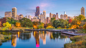 The Glimmering Lights Of The Chicago Skyline, Reflecting In The Waters Of Lake Michigan. Wallpaper