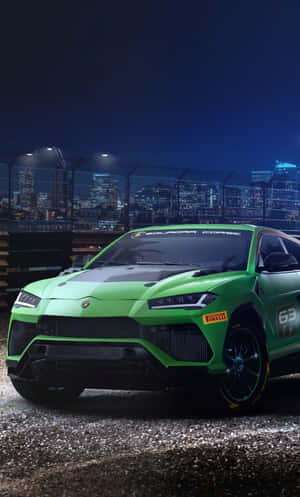 The Green Lamborghini Urus Is Driving Down The Street At Night Wallpaper