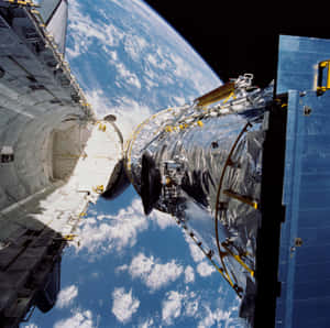 The Hubble Space Telescope Capturing An Awe-inspiring View Of The Vast Cosmos Filled With Galaxies, Stars, And Nebulas. Wallpaper