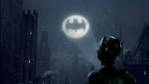 The Iconic Bat-signal Illuminating The Night Sky Over Gotham City Wallpaper