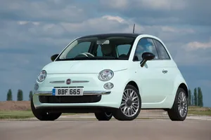 The Iconic Fiat 500 In Classic Design Cruising On The Open Road Wallpaper