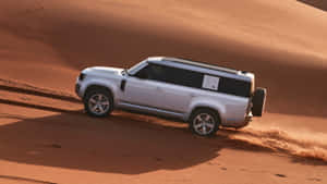 The Iconic Land Rover Defender In Its Natural Habitat Wallpaper