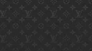 The Iconic Louis Vuitton Logo Atop A Brown Desktop Wallpaper