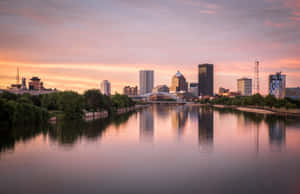 The Iconic Skyline Of Rochester, New York, Bathed In The Glow Of A Stunning Sunset. Wallpaper