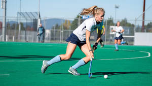 The Intense Rush - Field Hockey In Action Wallpaper