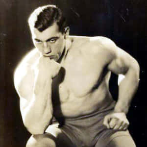 The Legendary Italian Boxer, Primo Carnera, Mirroring The Thinker Pose Wallpaper