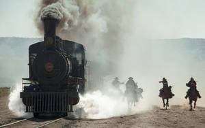 The Lone Ranger And Tonto On Horseback Overlooking A Steam Train. Wallpaper