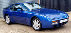 The Luxurious Porsche 944 In Vibrant Red Wallpaper