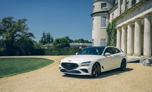 The Luxury Red Genesis G70 Sport Sedan In Action Wallpaper