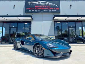 The Magnificent Mclaren 570gt Against A Sunset Backdrop Wallpaper