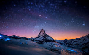 The Matterhorn At Night With Stars Above It Wallpaper