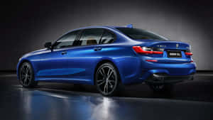 The New Bmw 3 Series Sedan Is Shown In A Dark Room Wallpaper